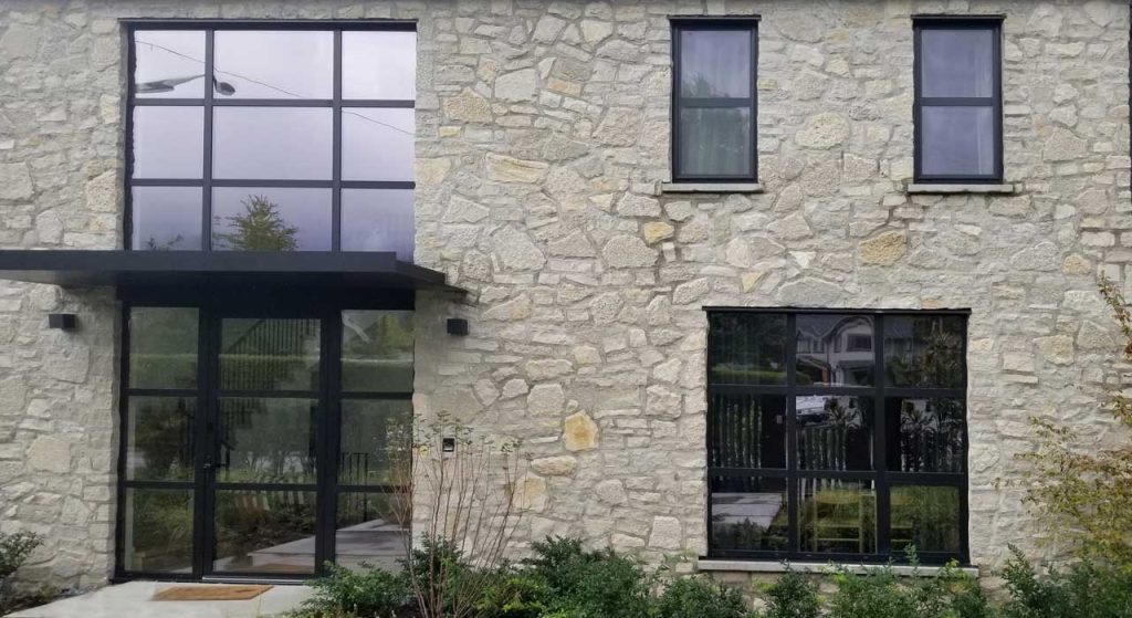 Natural Stone Cladding and Black Windows